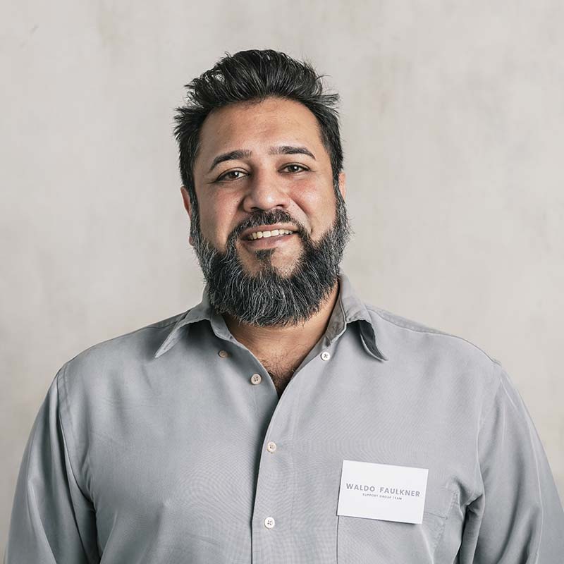happy indian salesman wearing a name tag LUBLBPX nella pagina Sentire